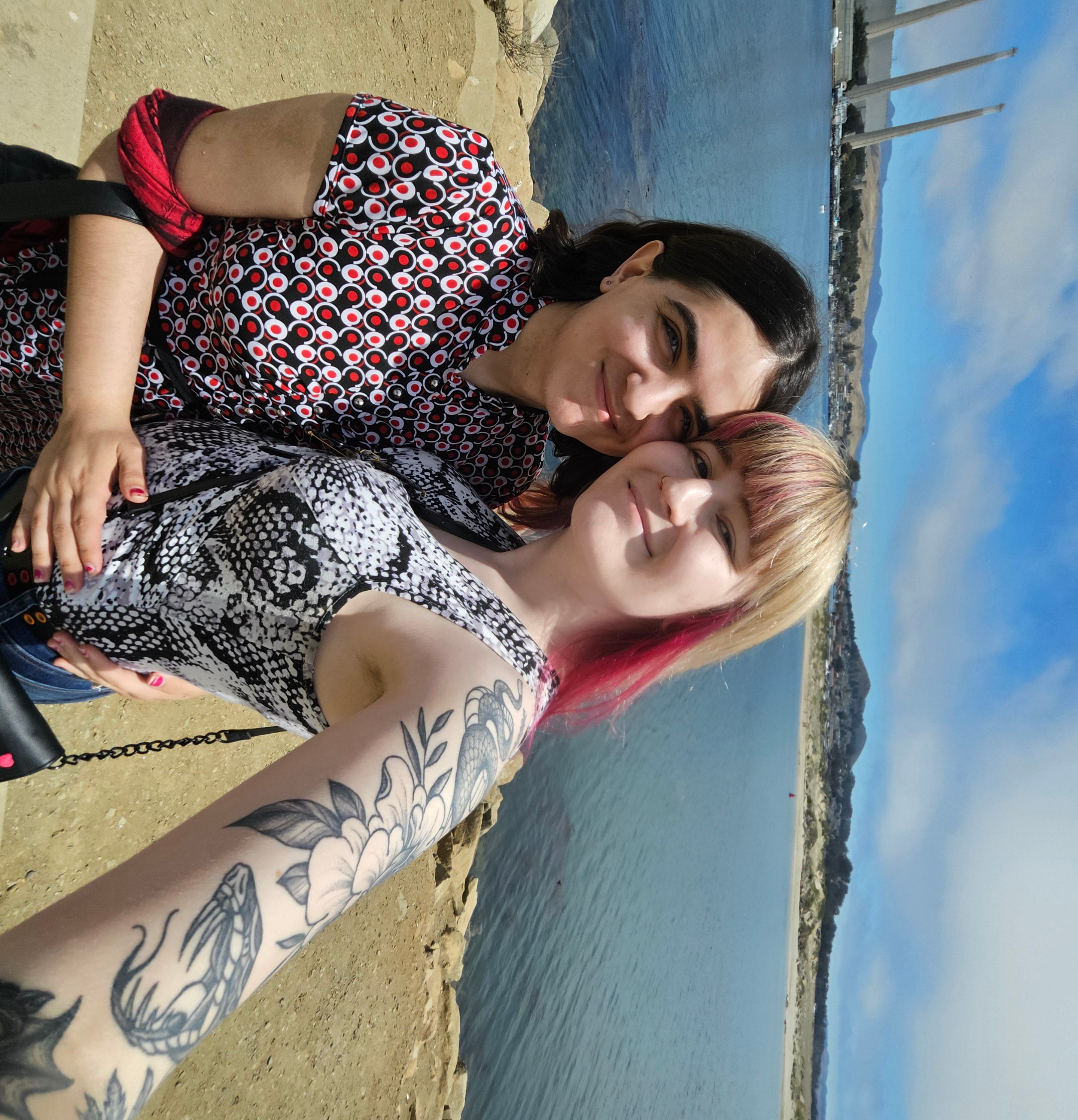 Allison and Violet at the beach, showing tattoo work